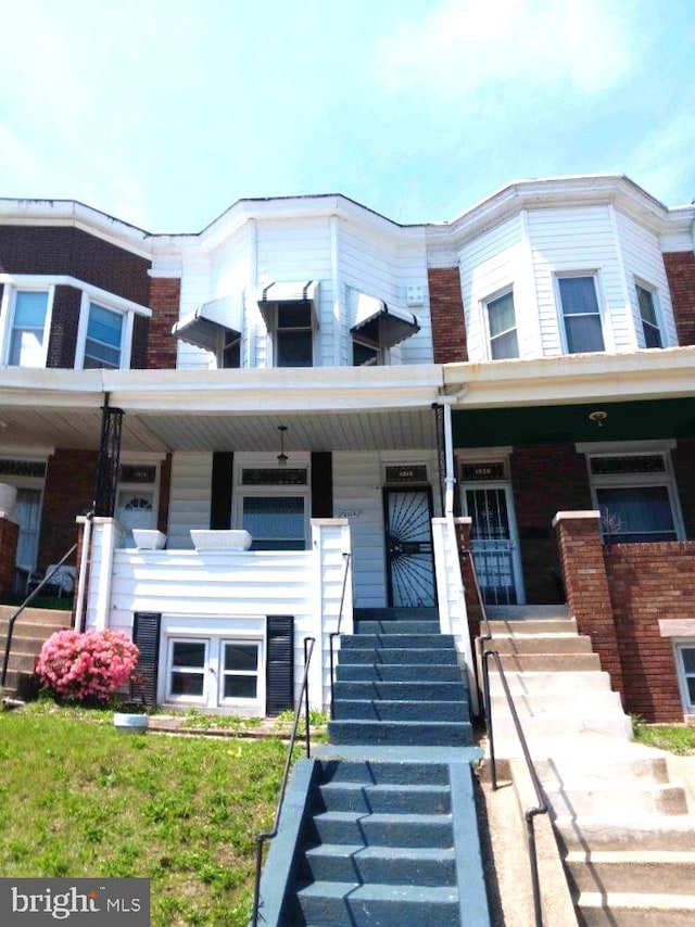 1018 N Bentalou St, Baltimore, MD 21216 - townhome / multi-family property with stairs and covered porch