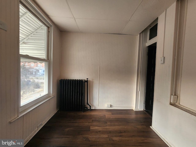 1018 N Bentalou St, Baltimore, MD 21216 - unfurnished room featuring a drop ceiling, wood finished floors, and radiator heating unit