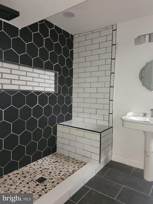 1018 N Bentalou St, Baltimore, MD 21216 - full bathroom with tile patterned flooring, baseboards, and tiled shower
