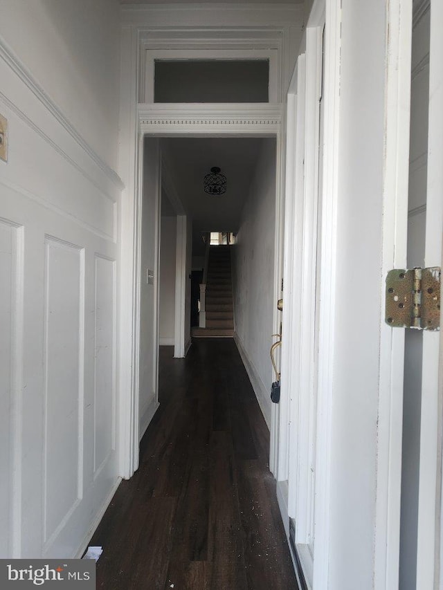 1018 N Bentalou St, Baltimore, MD 21216 - corridor featuring stairway, dark wood-style flooring, and baseboards