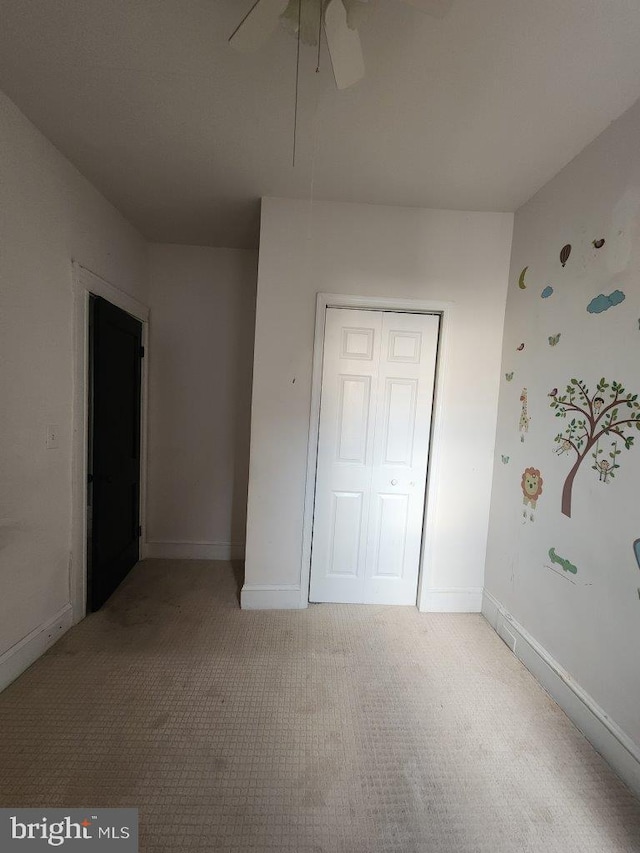 1018 N Bentalou St, Baltimore, MD 21216 - unfurnished bedroom with baseboards, a closet, a ceiling fan, and carpet