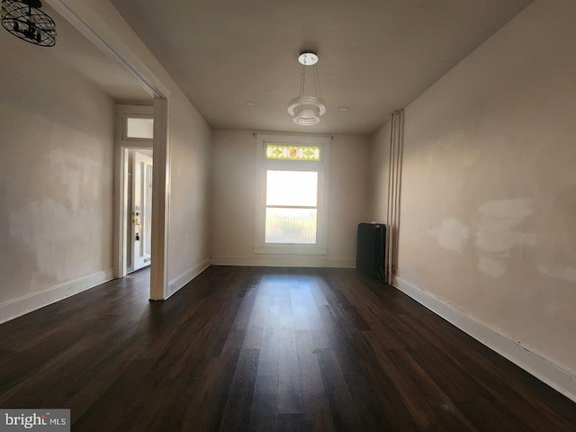 1018 N Bentalou St, Baltimore, MD 21216 - empty room featuring baseboards, a notable chandelier, and dark wood-type flooring