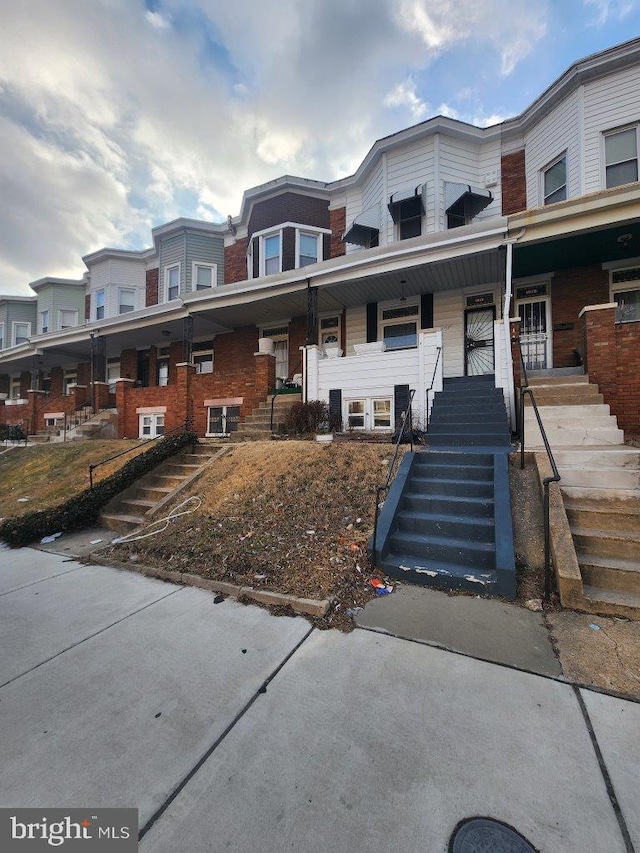 1018 N Bentalou St, Baltimore, MD 21216 - townhome / multi-family property featuring stairs and covered porch