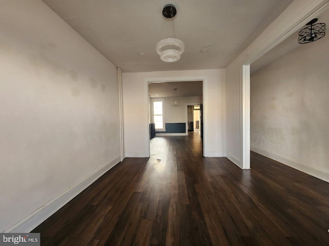 1018 N Bentalou St, Baltimore, MD 21216 - hall featuring a notable chandelier, baseboards, and dark wood finished floors