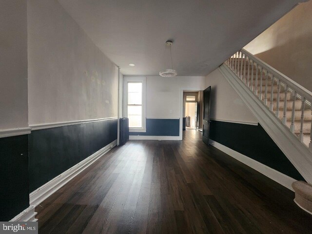 1018 N Bentalou St, Baltimore, MD 21216 - interior space featuring baseboards, stairs, radiator heating unit, and wood finished floors