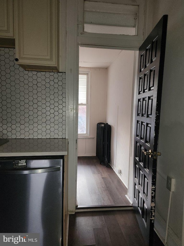 1018 N Bentalou St, Baltimore, MD 21216 - kitchen with dark wood finished floors, under cabinet range hood, cream cabinetry, light countertops, and stainless steel dishwasher