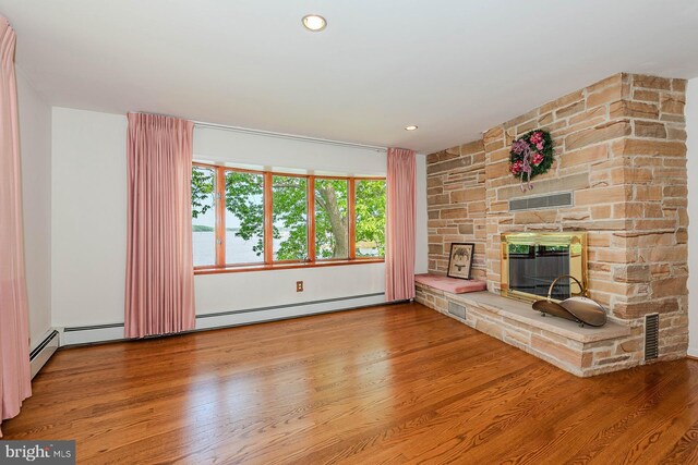 424 Alameda Pkwy, Arnold, MD 21012 - unfurnished living room with a fireplace, wood finished floors, and baseboard heating
