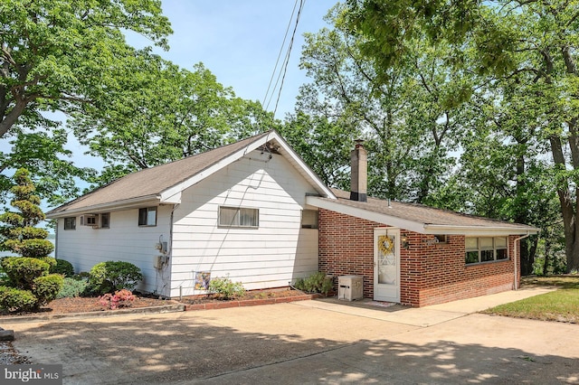 424 Alameda Pkwy, Arnold, MD 21012 - rear view of house with a chimney, brick siding, a shingled roof, and a patio area