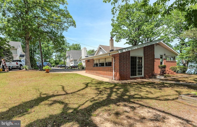 424 Alameda Pkwy, Arnold, MD 21012 - view of property exterior with brick siding, a yard, and a chimney