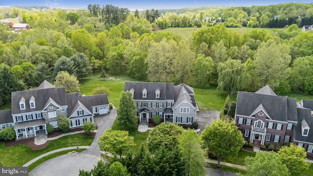 birds eye view of property featuring a wooded view