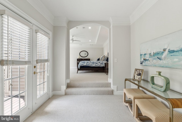 interior space with carpet, a healthy amount of sunlight, arched walkways, and crown molding