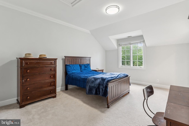 bedroom with baseboards, lofted ceiling, crown molding, and carpet floors