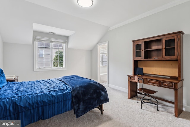 bedroom featuring visible vents, baseboards, ensuite bath, light carpet, and lofted ceiling