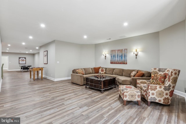 living room featuring recessed lighting, baseboards, and wood finished floors