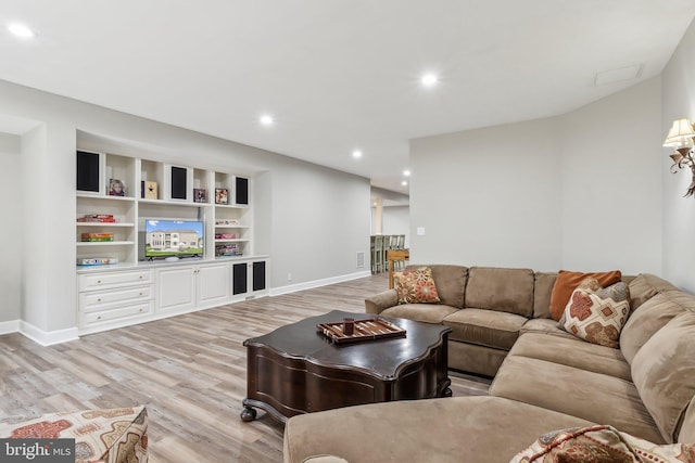 living room with baseboards, light wood-style flooring, and recessed lighting