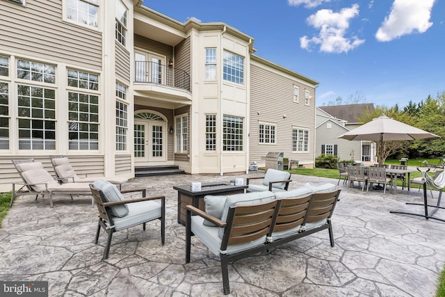 view of patio / terrace with french doors, outdoor dining space, area for grilling, a balcony, and an outdoor hangout area
