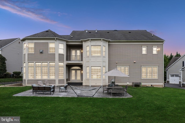 back of house featuring a yard, a patio area, french doors, and a balcony