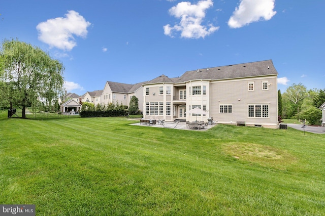 back of property featuring a yard and a patio