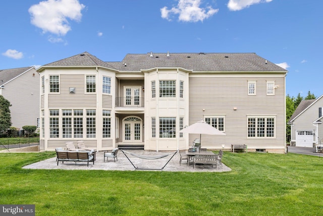 rear view of house with a patio, french doors, a lawn, and an outdoor living space