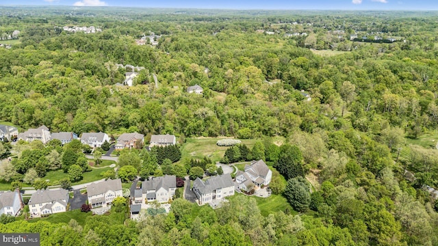 birds eye view of property featuring a wooded view and a residential view