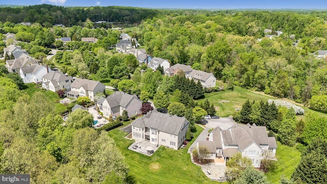 birds eye view of property with a residential view and a view of trees