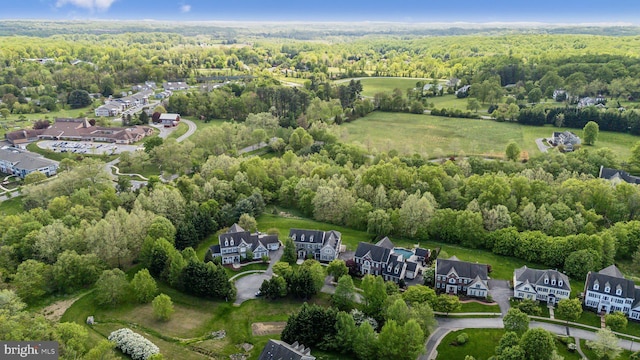 birds eye view of property with a forest view and a residential view