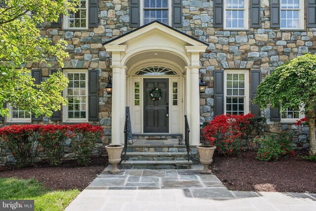 view of exterior entry featuring stone siding