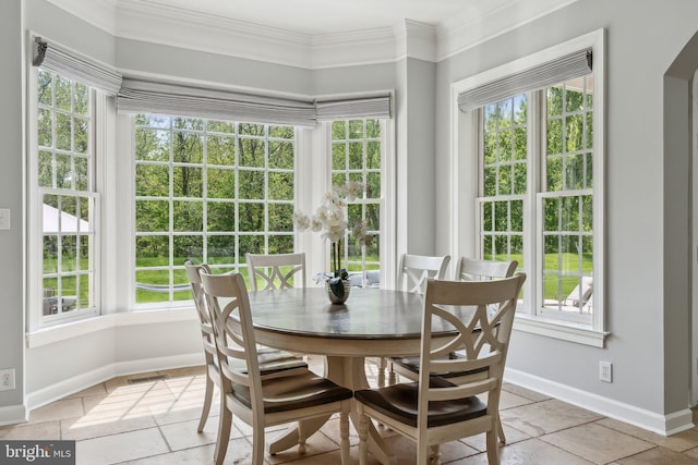 dining room with crown molding and a healthy amount of sunlight