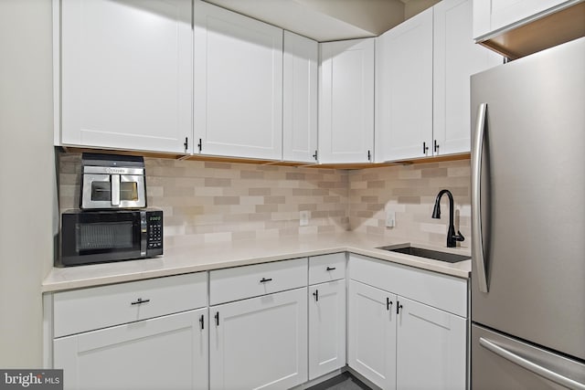 138 Merrimack Way, Arnold, MD 21012 - kitchen with freestanding refrigerator, black microwave, a sink, and white cabinetry
