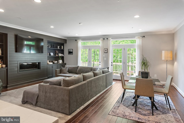 138 Merrimack Way, Arnold, MD 21012 - living area featuring ornamental molding, wood-type flooring, a large fireplace, recessed lighting, and built in shelves