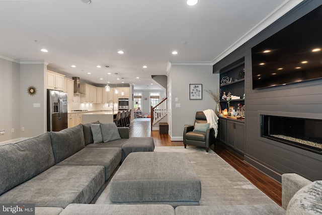 138 Merrimack Way, Arnold, MD 21012 - living area with dark wood finished floors, crown molding, a fireplace, recessed lighting, and stairway
