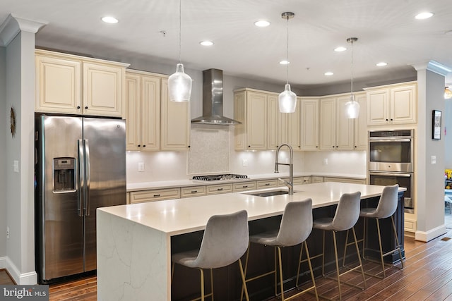 138 Merrimack Way, Arnold, MD 21012 - kitchen with appliances with stainless steel finishes, wall chimney range hood, a sink, cream cabinetry, and recessed lighting