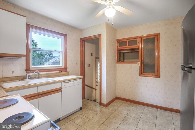 7423 Phelps Rd, Hanover, MD 21076 - kitchen with dishwasher, a sink, white cabinets, light countertops, and ceiling fan