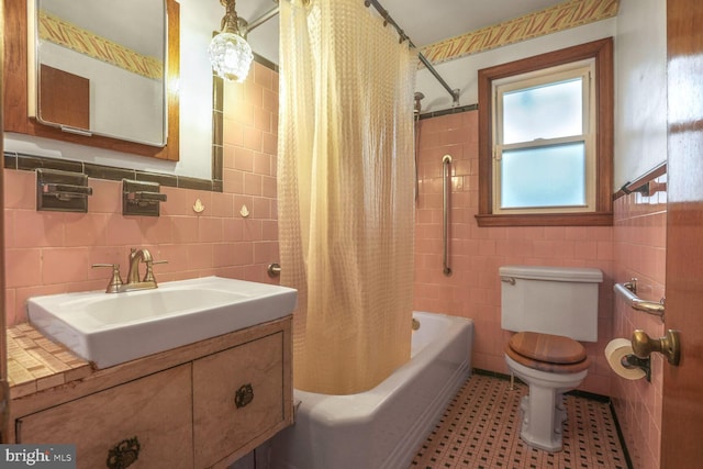 7423 Phelps Rd, Hanover, MD 21076 - full bath with tile walls, toilet, shower / bath combination with curtain, and vanity