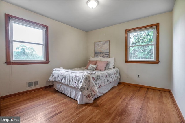 7423 Phelps Rd, Hanover, MD 21076 - bedroom featuring light wood-style floors, multiple windows, and baseboards