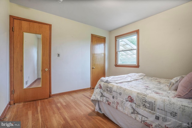 7423 Phelps Rd, Hanover, MD 21076 - bedroom with light wood-style flooring, baseboards, and a closet