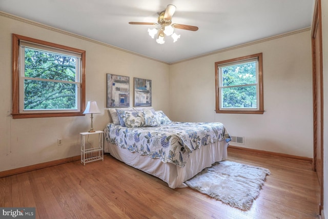 7423 Phelps Rd, Hanover, MD 21076 - bedroom with multiple windows, light wood-style flooring, baseboards, crown molding, and ceiling fan
