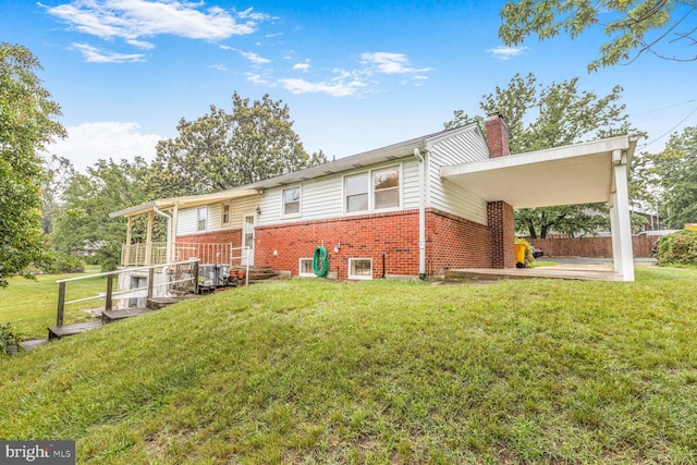 7423 Phelps Rd, Hanover, MD 21076 - rear view of house with brick siding, a chimney, a yard, and a patio