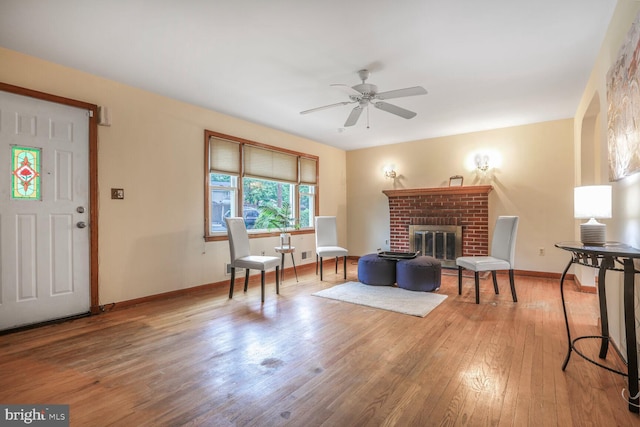 7423 Phelps Rd, Hanover, MD 21076 - living area featuring wood finished floors, baseboards, a ceiling fan, and a fireplace