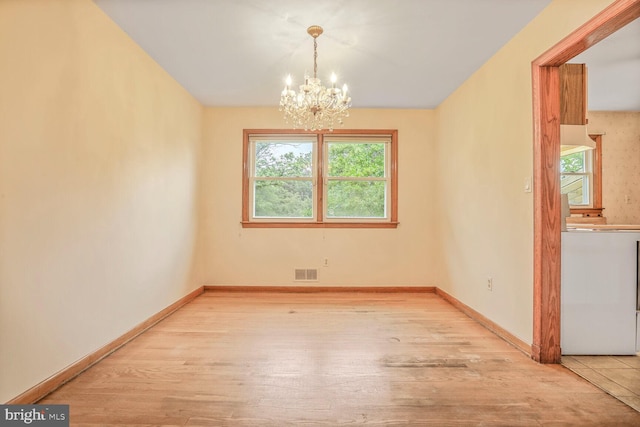 7423 Phelps Rd, Hanover, MD 21076 - unfurnished dining area featuring a chandelier, wood finished floors, and baseboards