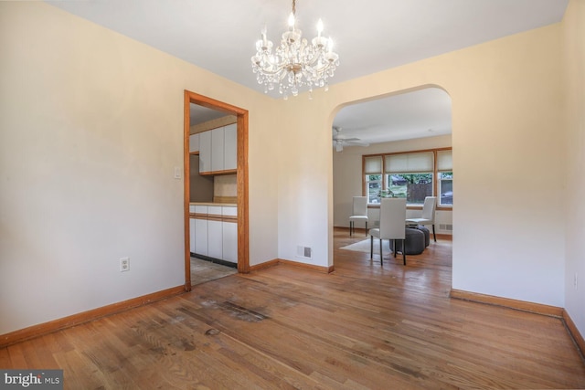 7423 Phelps Rd, Hanover, MD 21076 - dining area with arched walkways, wood finished floors, a chandelier, baseboards, and ceiling fan
