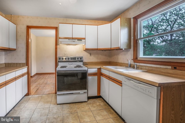 7423 Phelps Rd, Hanover, MD 21076 - kitchen featuring white appliances, under cabinet range hood, a sink, wallpapered walls, and white cabinets