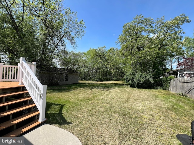 view of yard featuring stairway and a wooden deck