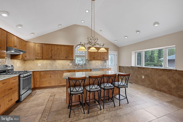 809 W 3rd Ave, Runnemede, NJ 08078 - kitchen with stainless steel gas range, under cabinet range hood, a breakfast bar area, recessed lighting, and a center island
