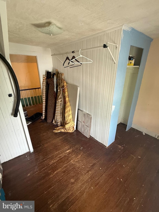 mudroom with a textured ceiling and wood-type flooring