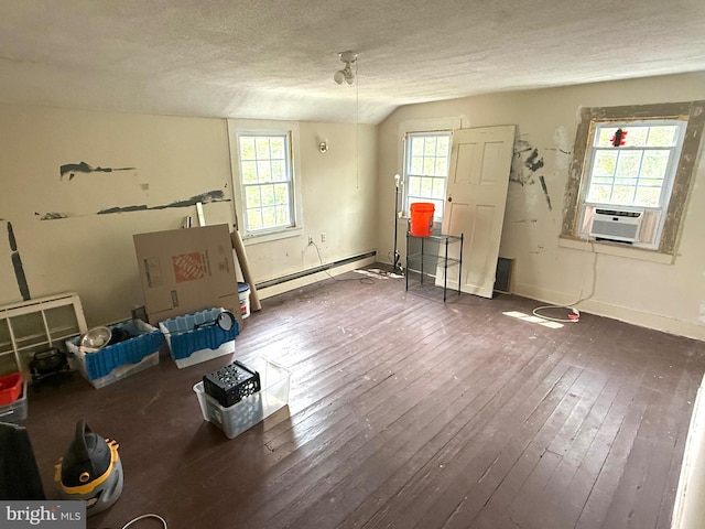 misc room featuring a textured ceiling, hardwood / wood-style floors, and baseboard heating