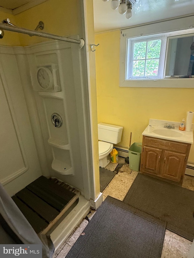 full bath with a shower stall, toilet, vanity, and a baseboard heating unit