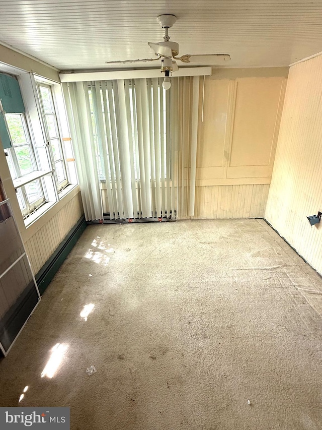 carpeted spare room featuring a ceiling fan