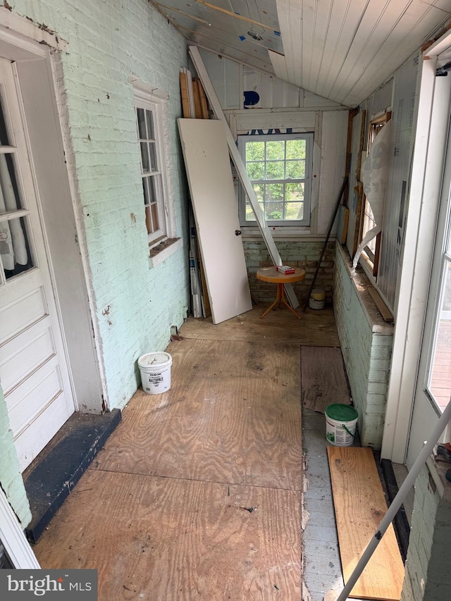 unfurnished room featuring lofted ceiling