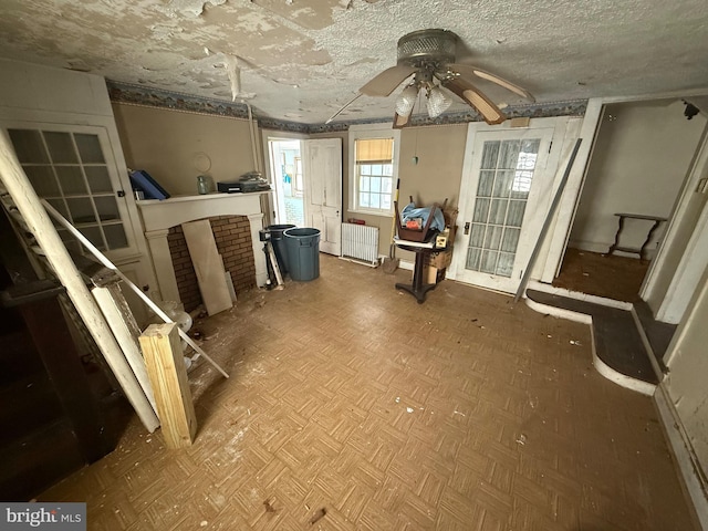 interior space featuring radiator and a ceiling fan